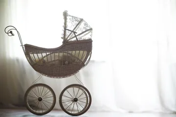 Vintage Wicker Baby Carriage in Soft Sunlit Room