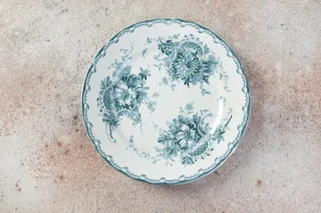 Antique porcelain plate on concrete